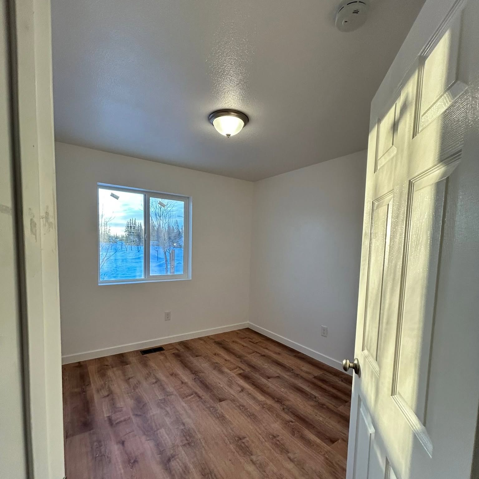 Plank flooring and new base trim, bedroom.