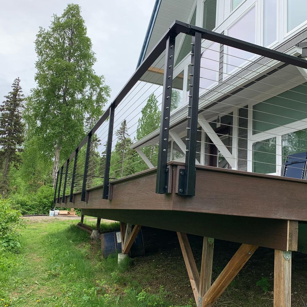 Raised deck with cable railing over a sloped yard