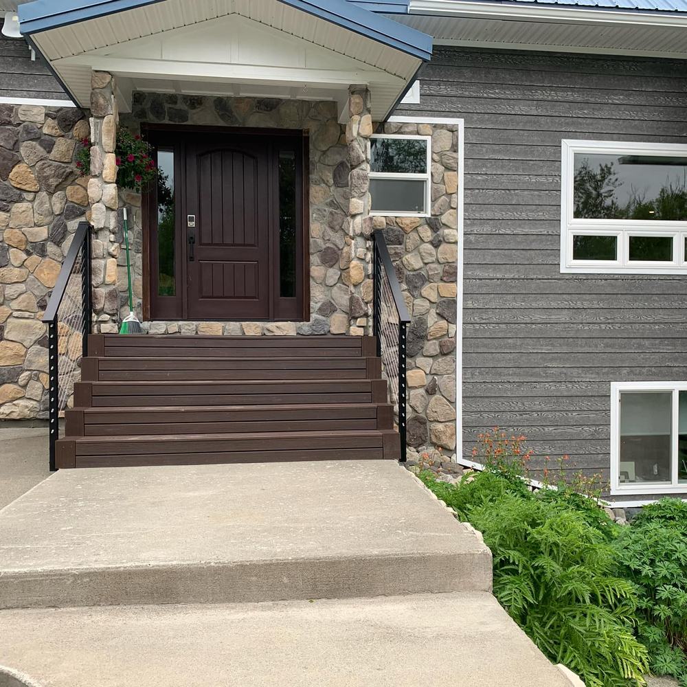 Stone faced entry, composite steps and black railing
