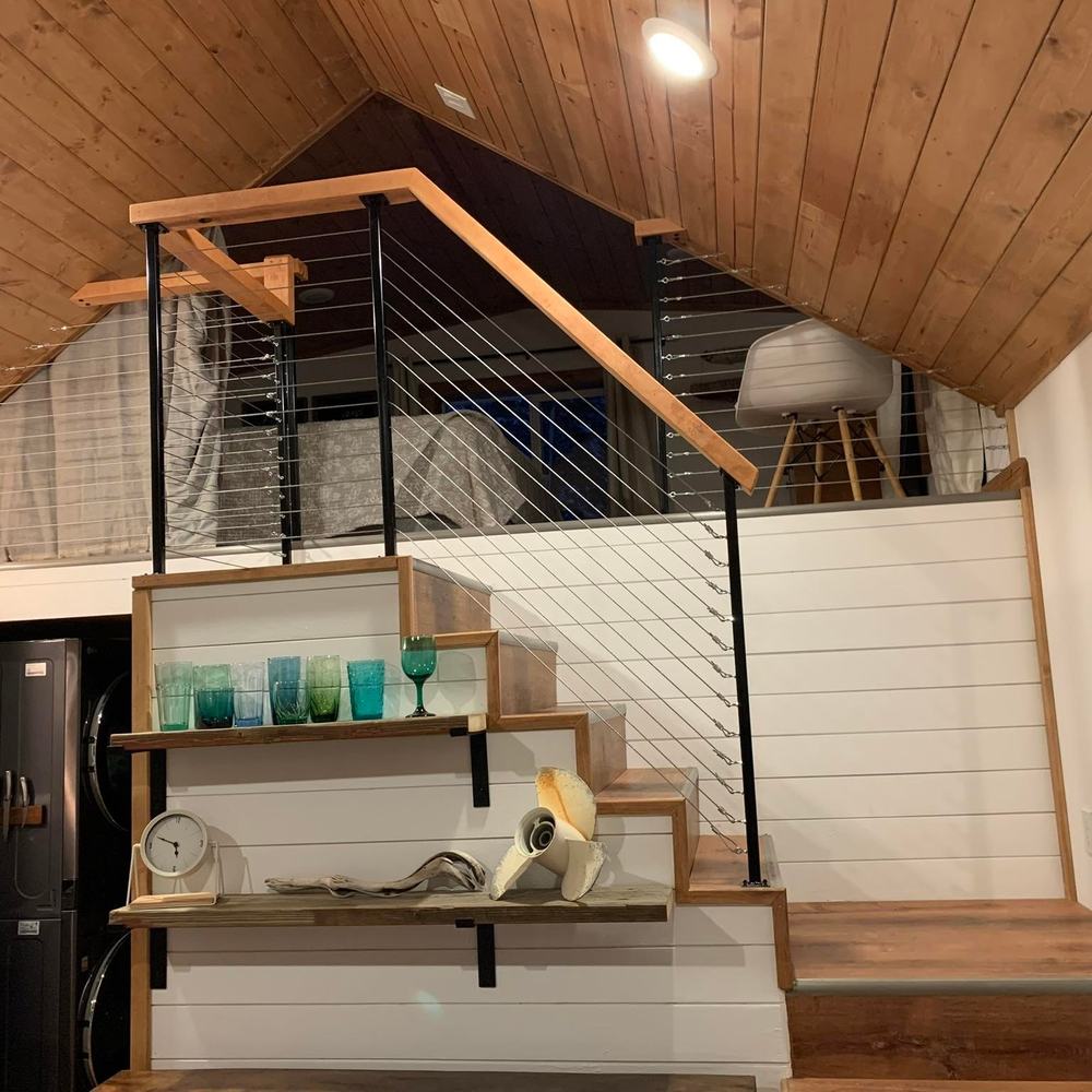 Open stair run up to a loft, square balusters and a timber handrail