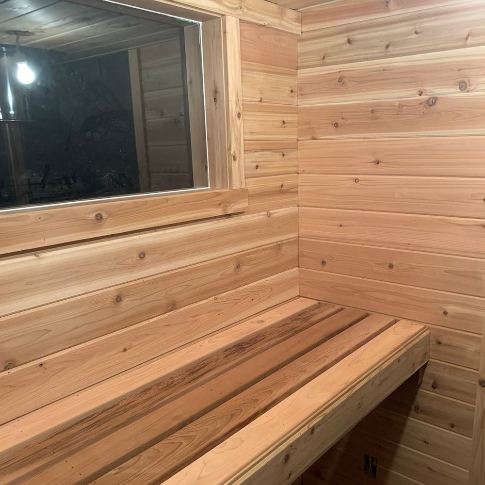 Cedar bench and window inside a finished sauna